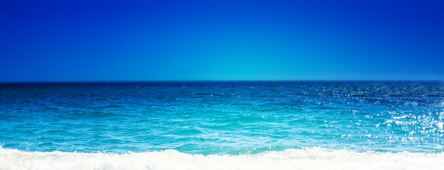 Wall Mural - Sea Beach and Soft wave of blue ocean.  Summer day and sandy beach background, beauty nature.