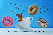 Flying multicolored donuts and a cup of coffee