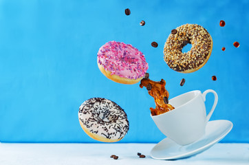 Wall Mural - Flying multicolored donuts and a cup of coffee