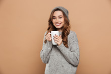 Cheerful Young Lady On Winter Warm Hat Drinking Tea