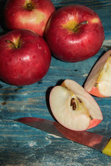 Red apples on a rustic blue table