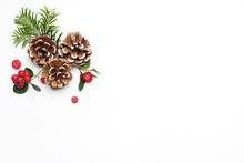Christmas Festive Styled Stock Image Floral Composition. Pine Cones, Fir Tree Branches And Red Gaultheria Berries On White Wooden Background. Flat Lay, Top View With Empty Copy Space.