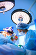 © Georgii - Surgeons operating a patient in operating room