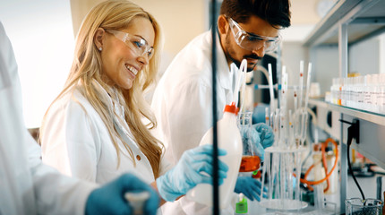 attractive student of chemistry working in laboratory