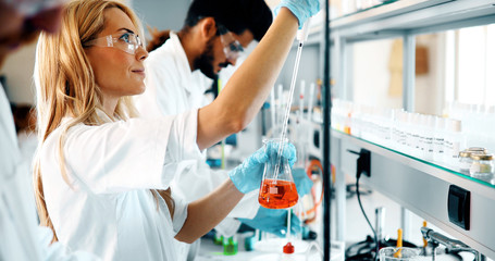female student of chemistry working in laboratory