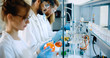 © NDABCREATIVITY - Young students of chemistry working in laboratory