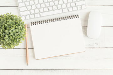 Wall Mural - flat lay photo of office desk with mouse and keyboard,empty open notebook on white wood table top vi
