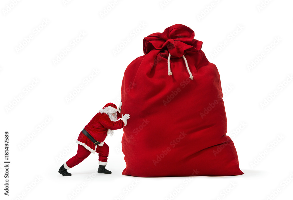 Close up of Santa Claus pushing huge bag of presents isolated on white ...