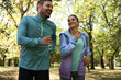 © liderina - Smiling couple run trough nature.