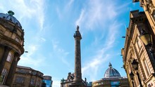 Newcastle Upon Tyne, UK. Charles Grey Monument In The City Center Of Newcastle Upon Tyne, UK During The Day. Time-lapse Of Moving Clouds, Blue Sky
