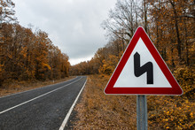 Traffic Sign On The Forest Road In The Autumn
