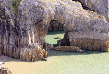 Wall Mural - Rock archway on sea shore Skrinkle Pembroke