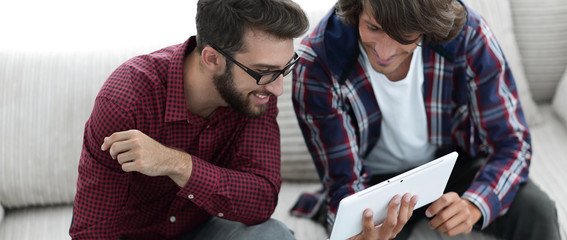 two creative web designers working with a tablet and a laptop.