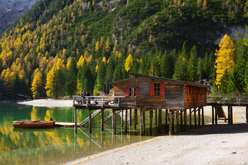 Amazing view of Braies Lake - Lago di Braies - with autumn forest and mountains reflected in surface lake water Dolomites Alps, Italy