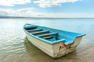 Naklejka na meble empty old wooden boat on shallow water