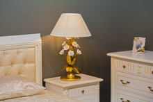 Luxury Royal White Bedroom In Antique Style. Bedside Table With A Chic Lamp
