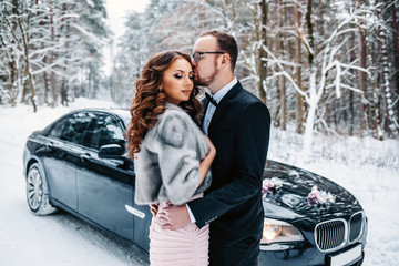 Gorgeous wedding couple embracing outside