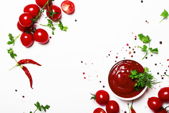 tomato ketchup sauce with spices and herbs with cherry tomatoes in a bowl on white food background, 