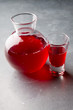 Glass jar with red vodka