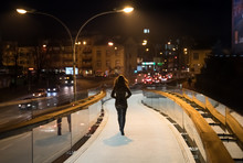 Woman Going Late Night On The Pedestrian Bridge