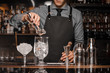 © fesenko - Bartender making a cocktail with help of the bar equipment