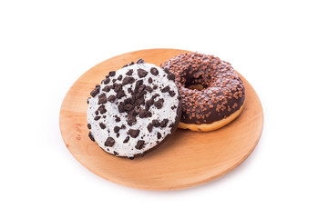 Donut with chocolate on wooden plate