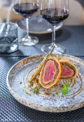 Grilled steak meat with potato gratin and glass of red wine