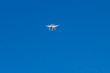 drone with the camera hovering in blue sky