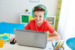 © Syda Productions - boy in headphones playing video game on laptop