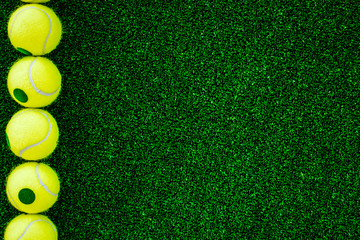 Wall Mural - tennis ball on green background top view mock up