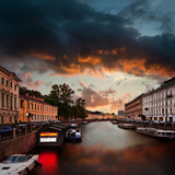 Fototapeta Big Ben - Canal with Moyka river in Saint-Petersburg with dramatic cloudy sky. View from Nevsky Prospect.