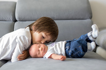 Sticker - Sweet preschool boy, hugging with tenderness and care his little newborn brother