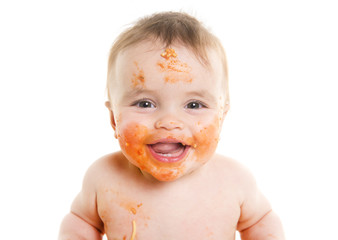 little baby eating her dinner and making a mess on his face