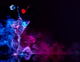 martini cocktail splashing in blue and purple smoky background