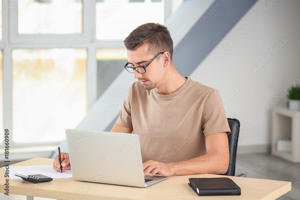 Attractive man with laptop at home
