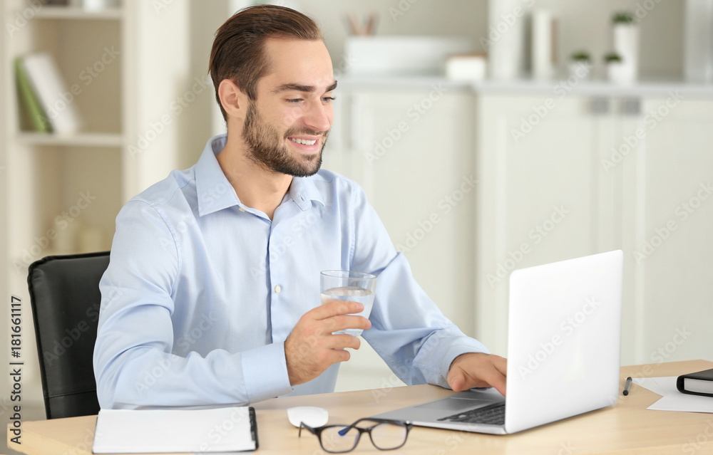 Attractive man with laptop in office