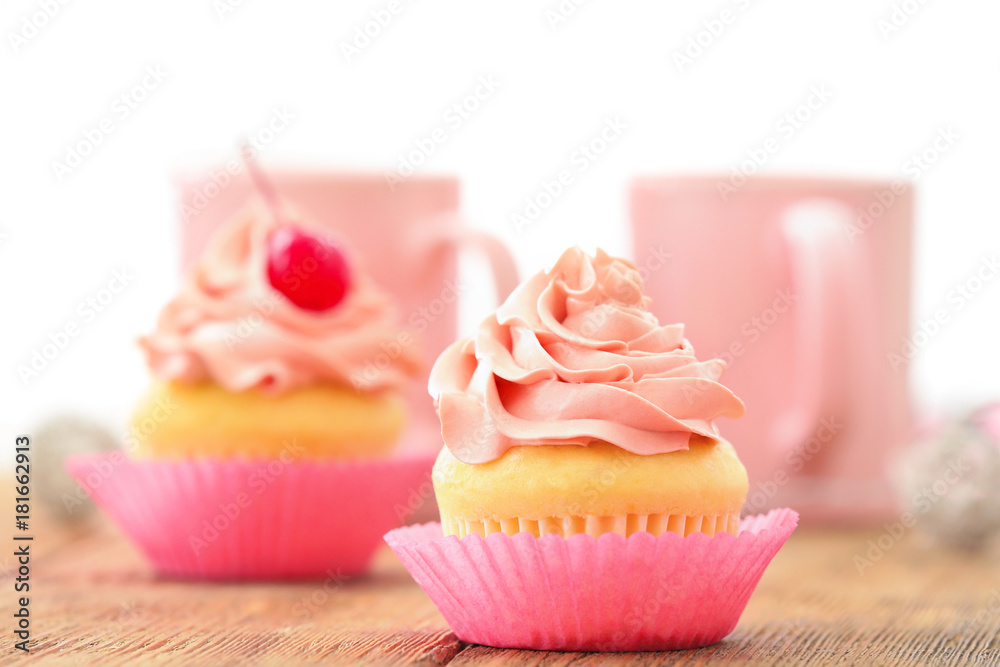 Delicious vanilla cupcake on table