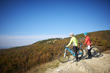 Two female cyclist enjoying the beautiful scenery while out mountain biking.