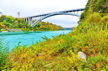 Wall Mural - view of niagara river and rainbow bridge at the downstream of niagara falls in autumn.