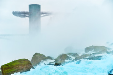 Wall Mural - view from the bottom of niagara falls at american side with water splashing in the air