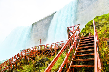 Wall Mural - view from the bottom of niagara falls at american side with water splashing in the air
