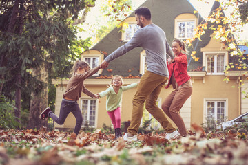 Wall Mural - Family playing together outside. On the move.