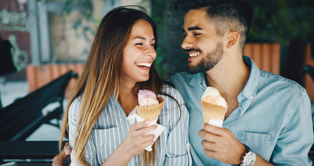 Wall Mural - Happy couple having date and eating ice cream