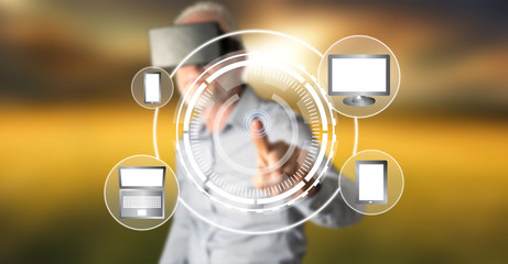 Wall Mural - man wearing a reality virtual headset touching a device connection concept on a touch screen