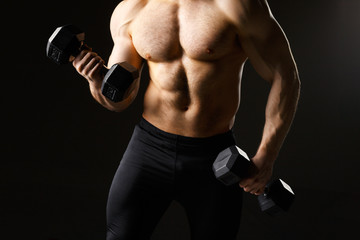 Powerful muscular man holding metal workout weight