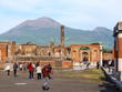 Roman forum, main square of the roman city of Pompeii ruins with dormant volcano Mount Vesuvius in the background