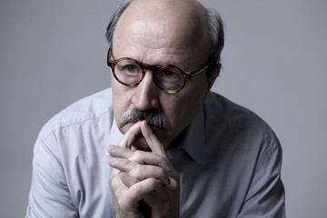 Wall Mural - head portrait of senior mature old man on his 60s looking sad and worried suffering pain and depression in sadness face expression