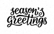 Seasons greetings calligraphy lettering text on white background with vintage paper texture. Retro greeting card for Christmas and New Year holidays. Vector background