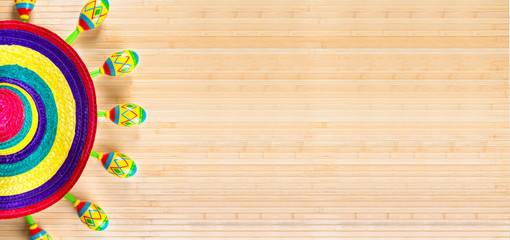 Mexico.Colored sombrero  and maracas on a wooden background.	