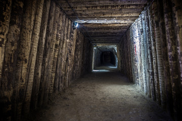 Illuminated underground tunnel in old mine